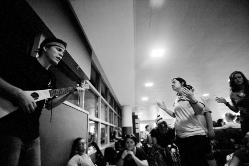 A squad worshipping in the JFK airport before beginning the race